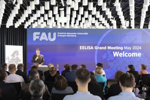 Depicted is FAU president Joachim Hornegger, standing on a stage. From May to November 2024, FAU President Prof. Dr. Joachim Hornegger holds the chair for the EELISA Governing Board. (Image: FAU/Giulia Iannicelli)